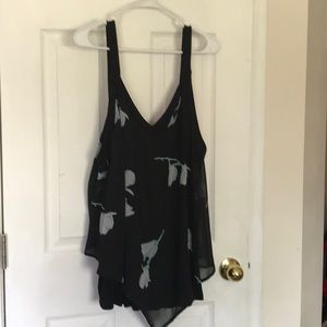In every story..sleeveless blouse w/ blue feathers